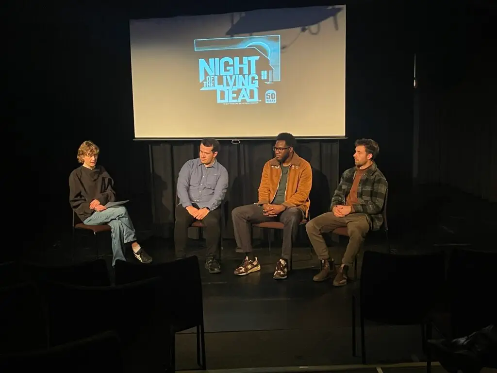 4 people sitting on chairs on the stage at the Palmerston Public Library Theatre